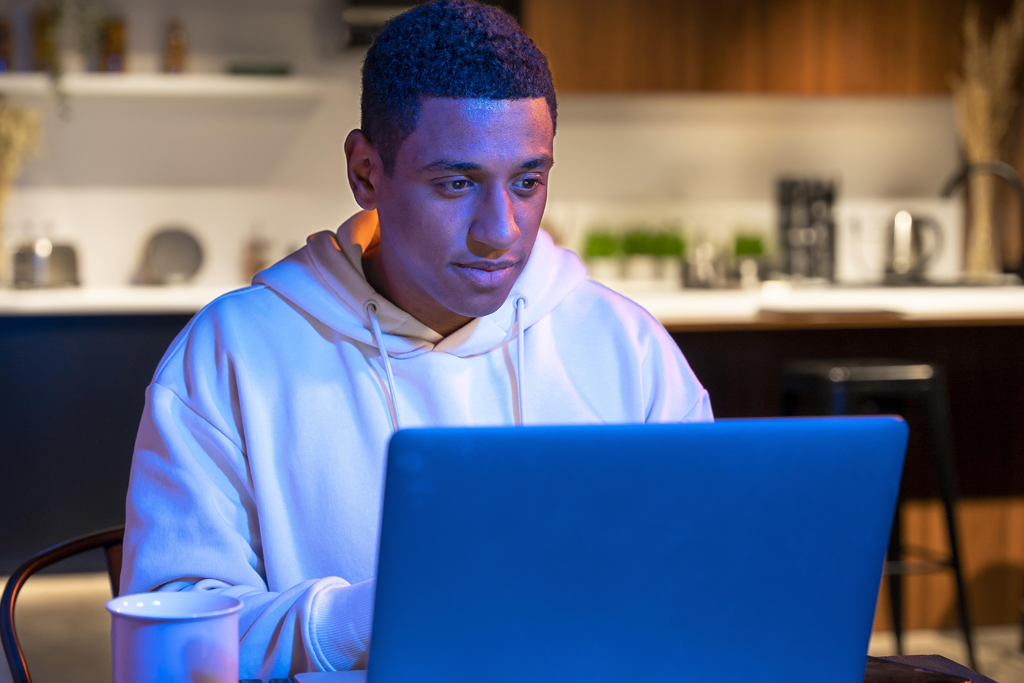 young developer reading a salary guide in kitchen